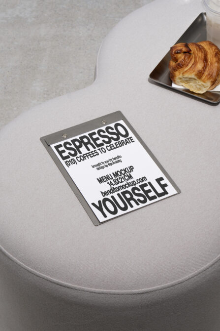 Menu mockup on minimalist table with croissant and coffee. Ideal for showcasing cafe graphics and templates. Keywords: Mockup, Menu, Design, Graphic