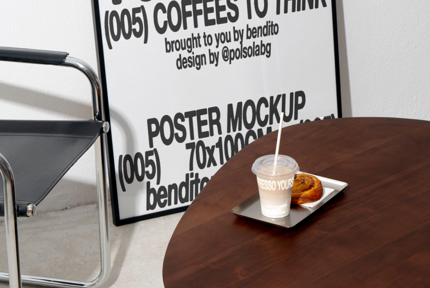 Poster mockup in interior setting with chair and table including coffee cup and pastry. Ideal for designers seeking stylish mockups and graphic templates.