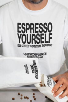 White crewneck tee with white coffee bag mockup held in front by model