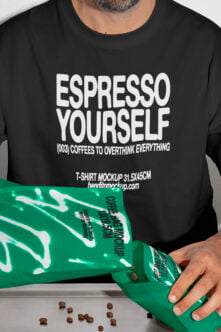 Black crewneck tee with green coffee bag mockup held in front by model