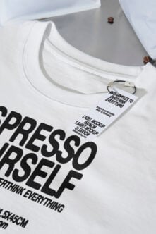 White crewneck tee with hang tag showing label mockup for coffee design