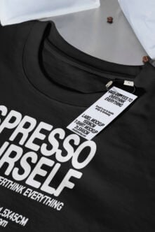 Black crewneck tee with hang tag showing label mockup for coffee design