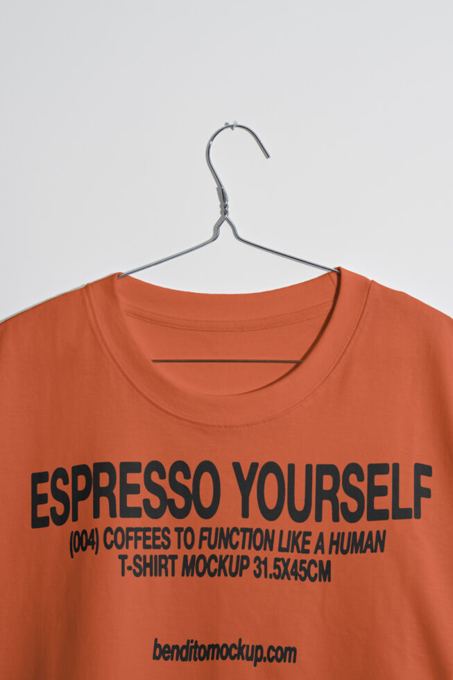 Orange t-shirt mockup with Espresso Yourself text, hanging on a hanger. Ideal for designers seeking apparel graphics, typography, or merchandise display.