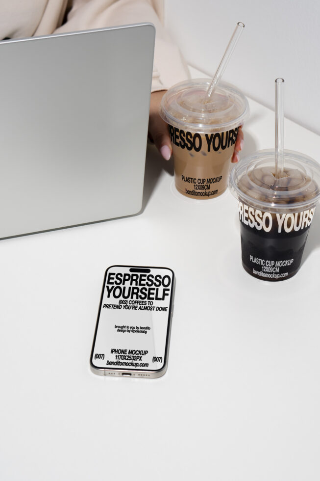 Laptop with iced coffee cups and iPhone displayed on white desk. Perfect for beverage branding mockups or showcasing design assets for designers.