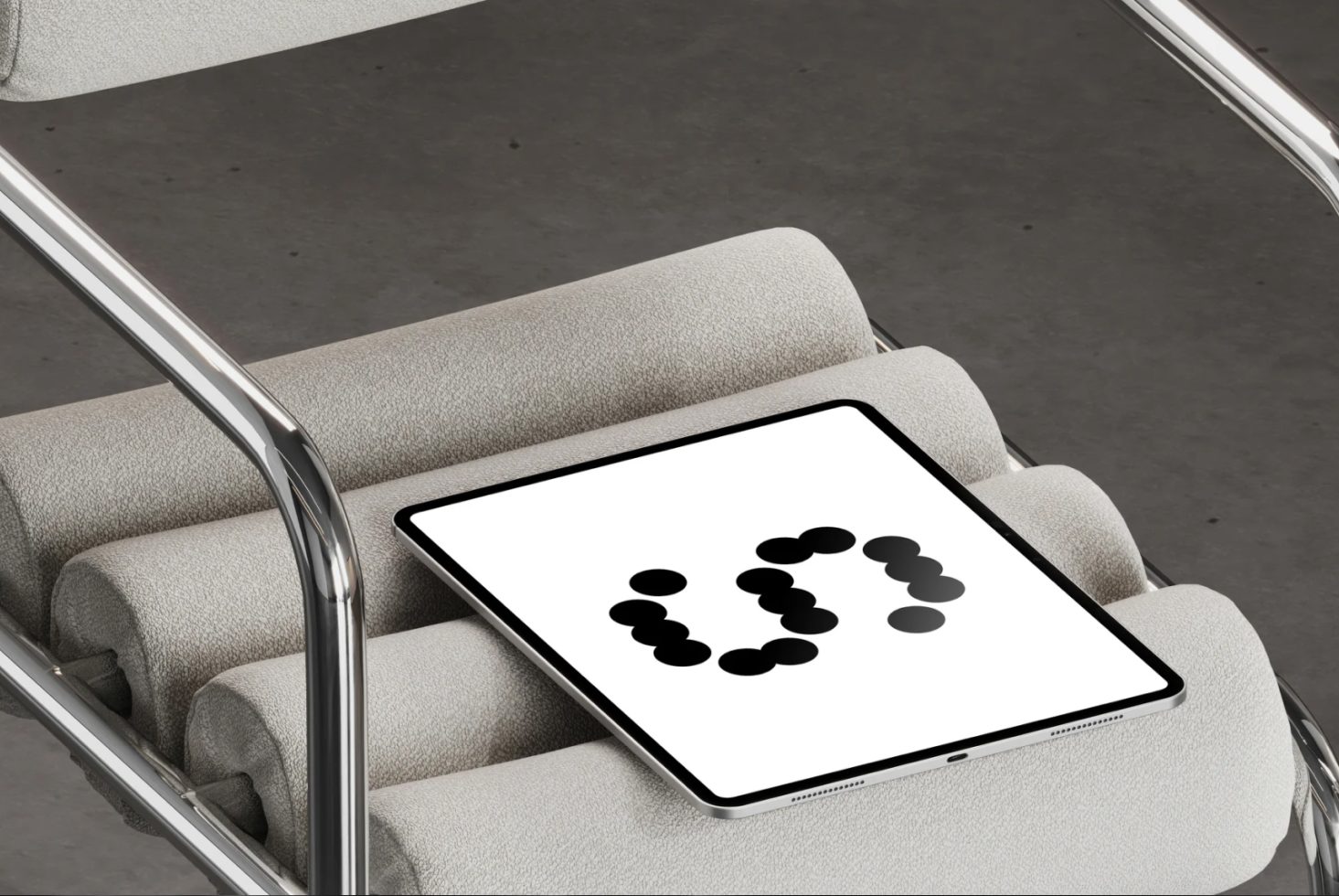 Tablet mockup on a modern chair featuring black dot graphics on the screen suitable for designers looking for minimalistic design resources templates