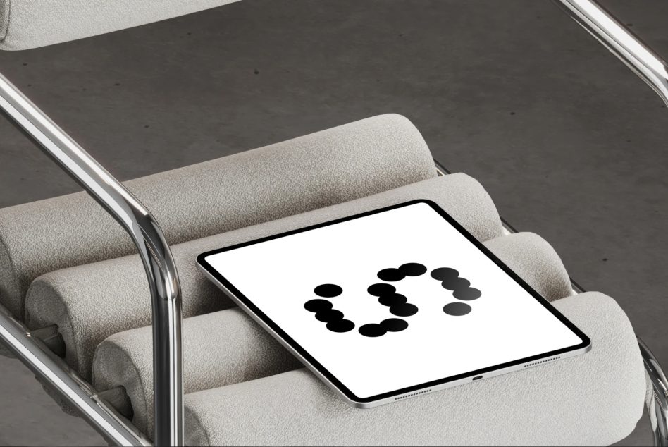Tablet on gray upholstered chair arm showing dots in ring layout