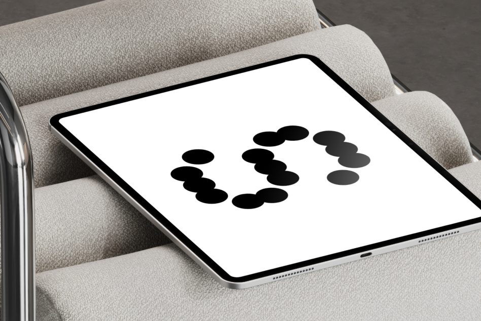 Tablet on beige linen sofa displaying circular arrangement of black dots