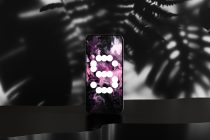 Device mockup with blurred foliage backdrop, liquid ink wallpaper, circular dot pattern