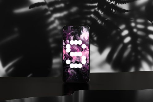 Smartphone mockup featuring a modern abstract digital art background with pink and black tones suitable for designers seeking unique graphic templates.