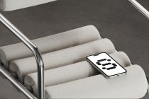Phone on cream ribbed furniture showing dotted number 3