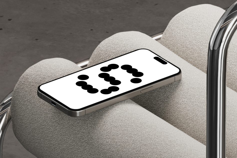 Phone on beige cushioned chair arm displaying number 3 dots