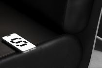 Phone resting on black leather couch displaying dotted 3