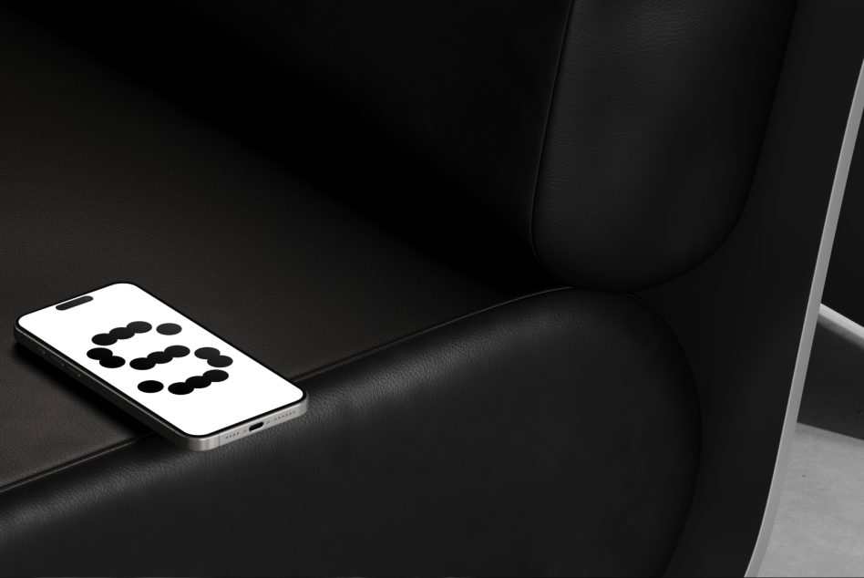Phone resting on black leather couch displaying dotted 3