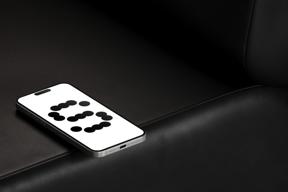 Silver phone on black leather showing number 3 in dots