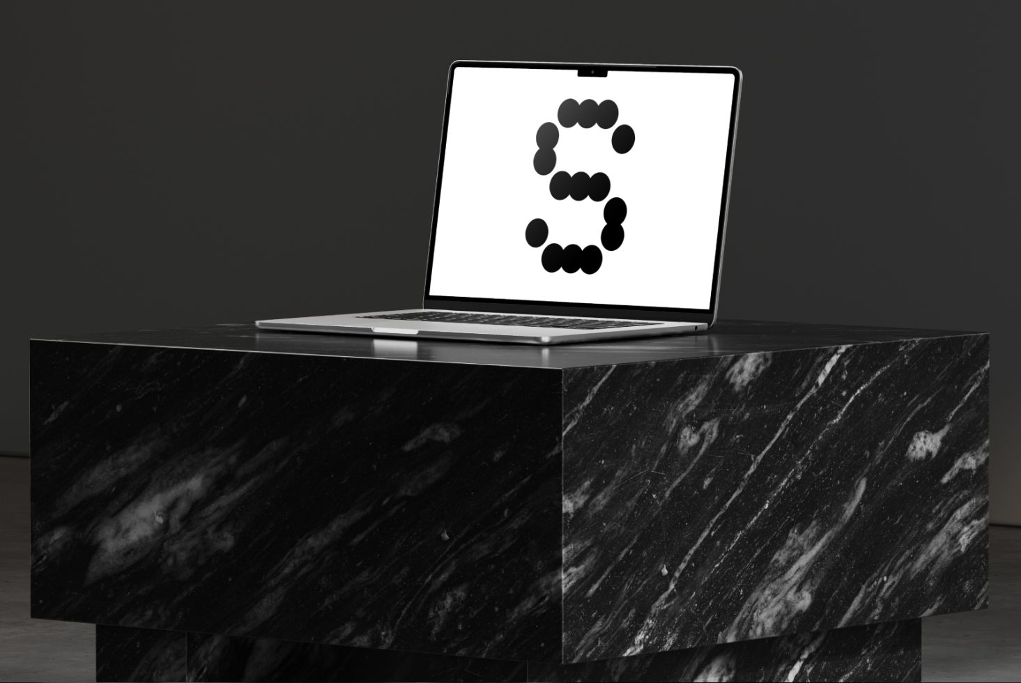 Laptop mockup on a black marble pedestal with a minimalist screen display showing a stylized letter. Ideal for showcasing digital design assets.