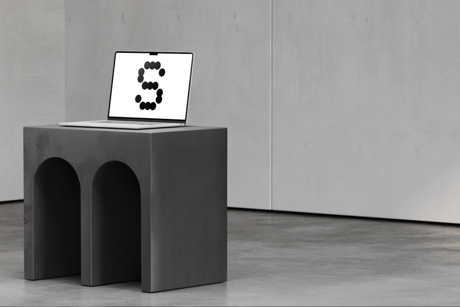 Laptop on concrete pedestal showing number 3 formed by black circles