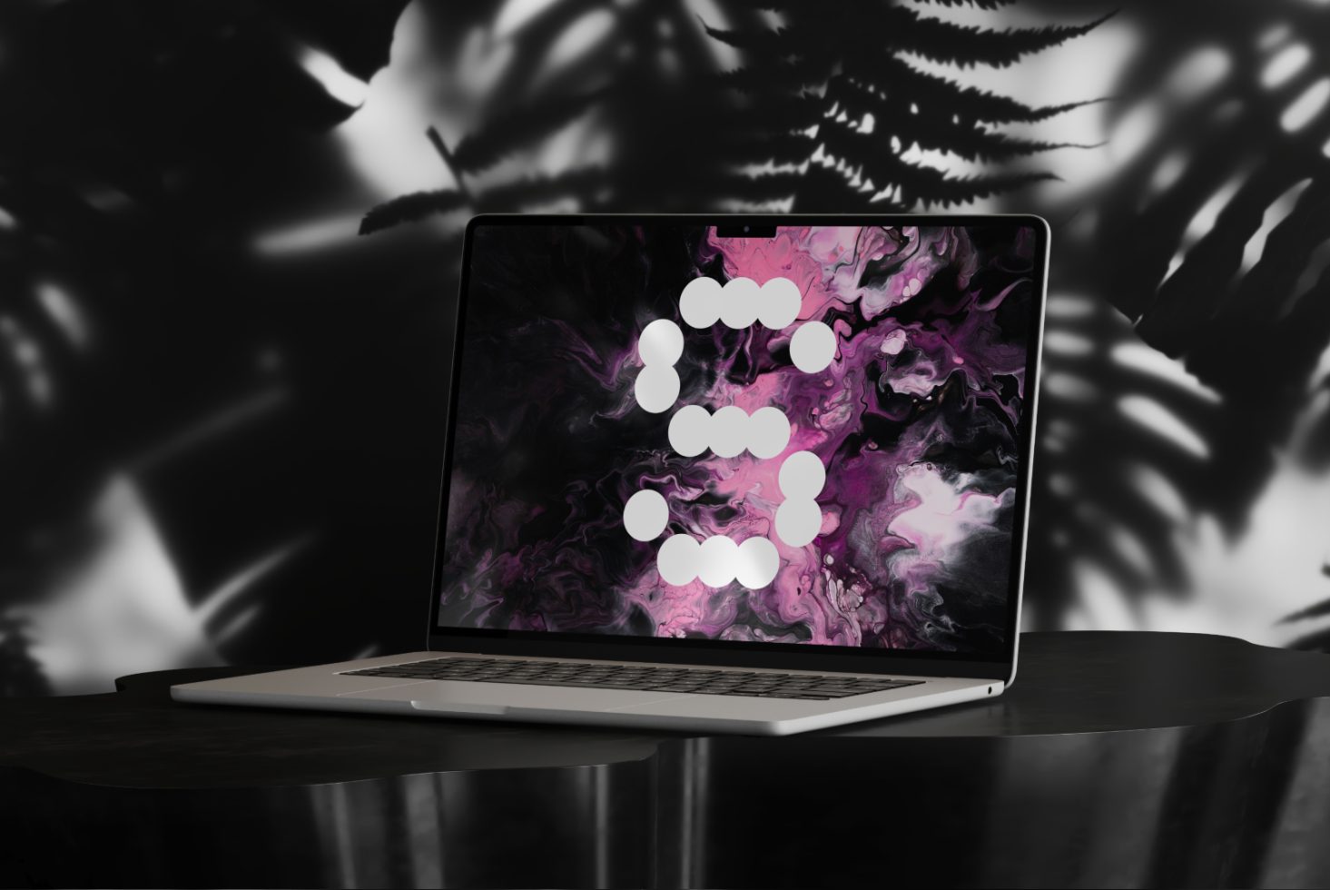 Laptop mockup displaying abstract pink and black digital art on the screen. Suitable for designers needing graphic templates. Modern workspace design.