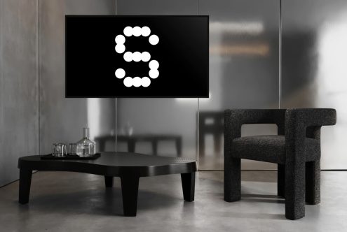 Modern living room with minimalist black furniture featuring a unique digital graphic on screen. Ideal for interior design mockups and digital showcases.