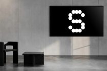 Horizontal screen displaying dotted circle number against concrete wall