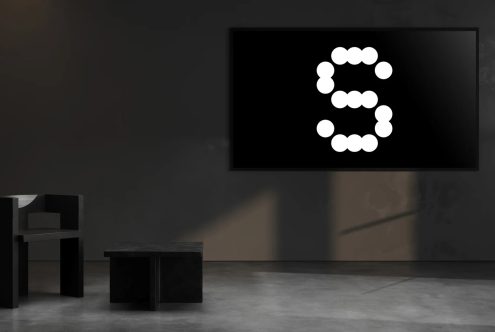 Modern interior design mockup featuring a black wall art with a large stylized letter S glowing in white dots. Ideal for creative digital assets.