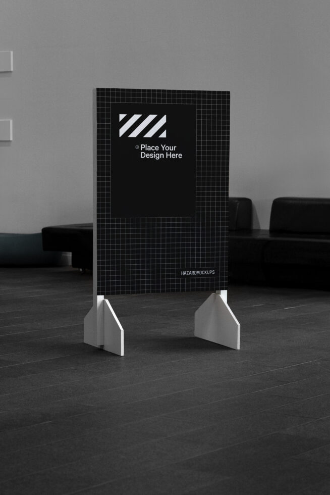 Standing poster mockup in an office setting with a grid background for designers. Design placeholder for Templates and Graphics. Black and white theme.