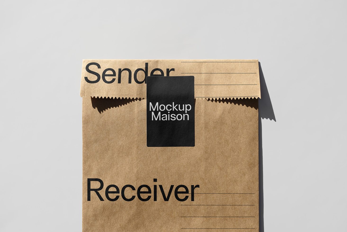 Top view of a kraft paper envelope mockup labeled Sender and Receiver with a black sticker that reads Mockup Maison placed on a gray background.