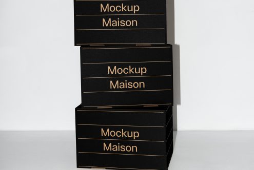 Stacked black boxes mockup with gold text reading Mockup Maison useful for presenting packaging designs box mockups templates for designers and branding visuals