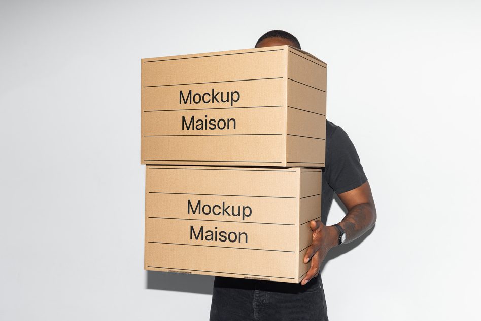 Person holding two kraft cardboard boxes stacked with minimal text layout