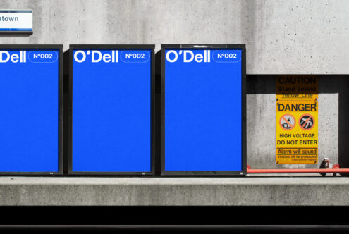 Blue urban signage mockup on a concrete wall with a caution sign nearby. Ideal for graphic design templates, advertising materials, and brand displays.