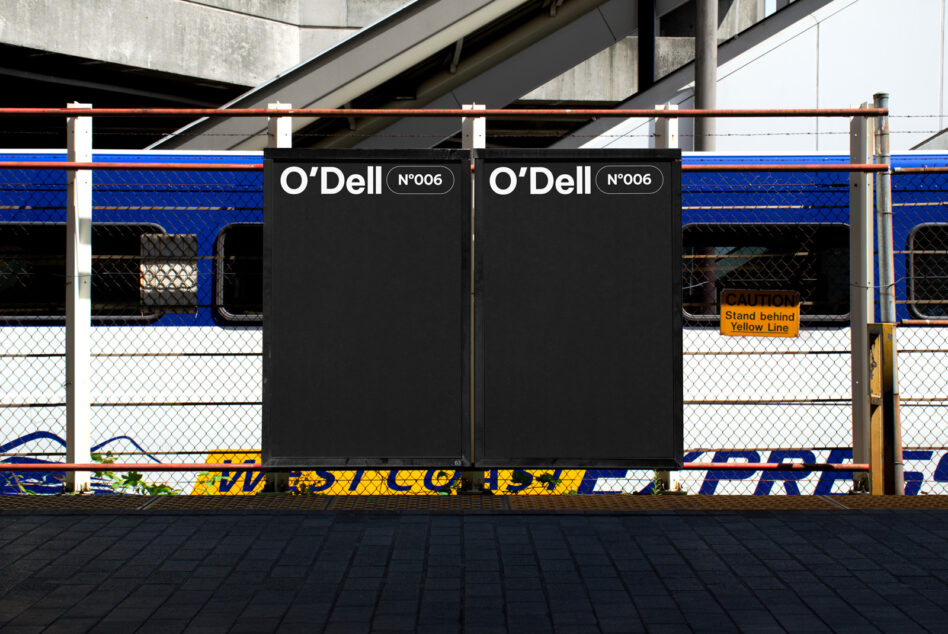 Mockup of two black billboards with text O'Dell No006 in urban setting, train and caution sign in background; ideal for transit advertising design.