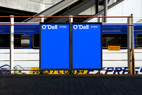 Train station billboard mockup featuring two bright blue posters against a fence background. Ideal for graphic design presentations. Urban advertising.