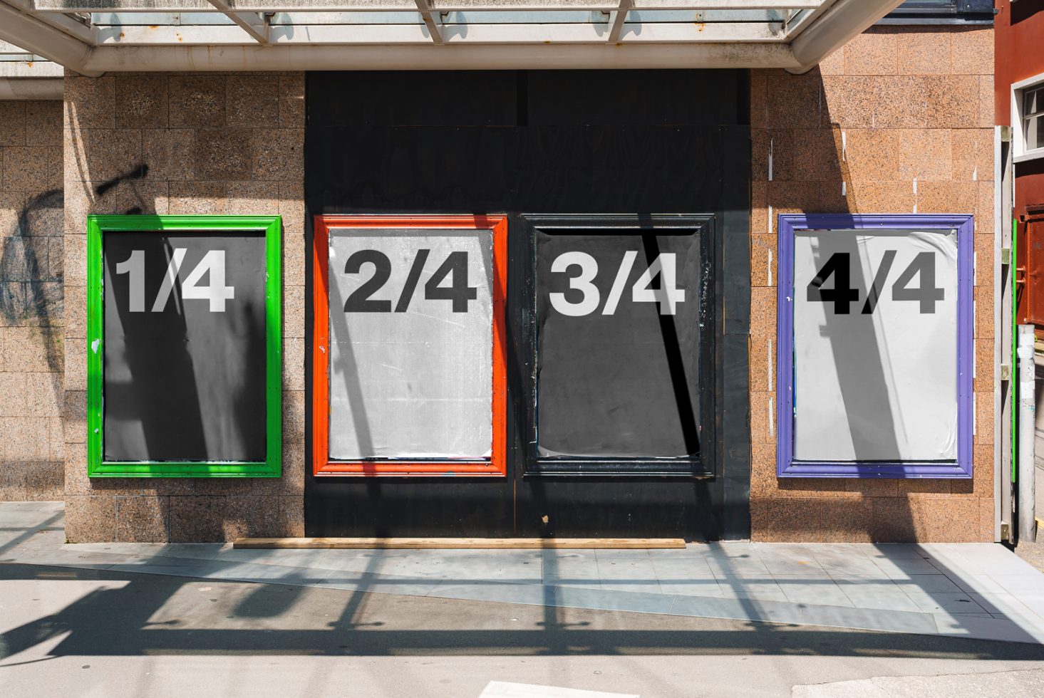 Urban poster mockup showcasing four frames with colorful borders on a concrete wall. Ideal for displaying graphic designs and advertising layouts.