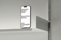 iPhone 16 Pro mockup with white screen on white shelf in studio setting