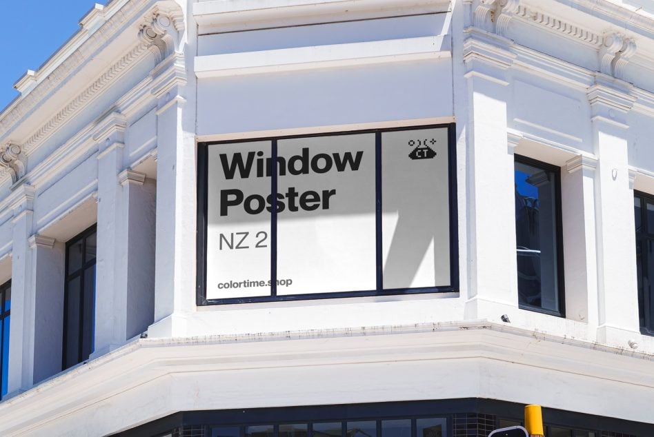 Window poster mockup on storefront with ornate architecture, bright sunlight, large blank space for design