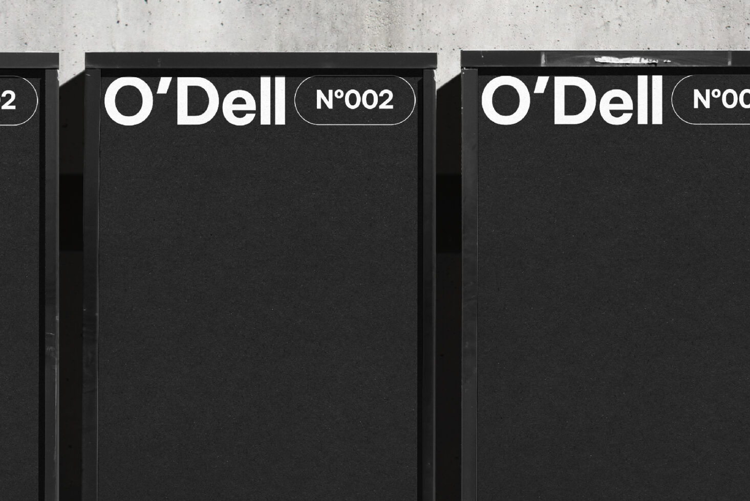 Minimalistic black signage mockup featuring O'Dell branding and number 002. Perfect for graphic designers seeking modern design inspiration and templates.