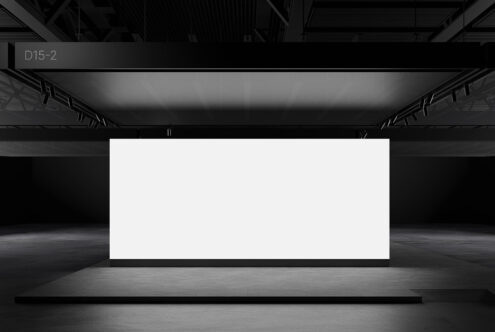 Large blank screen in a dimly lit exhibition space ideal for mockup display. Perfect for designers seeking a customizable digital canvas.