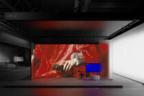 Classical red painting displayed on warehouse billboard with blue monitor