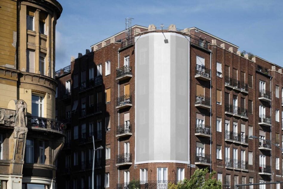 Curved building facade with blank white banner mockup covering corner