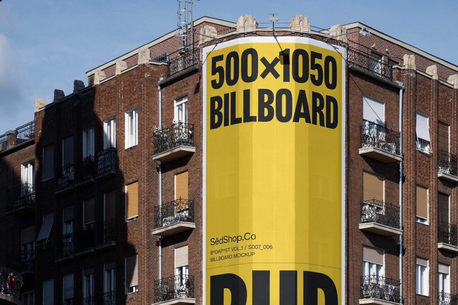 Large vertical billboard mockup on brick building corner featuring yellow background and black text ideal for urban advertising template design.