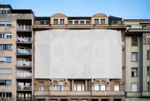 Urban building facade mockup with blank billboard for design presentation surrounded by residential architecture showcasing cityscape exterior design.