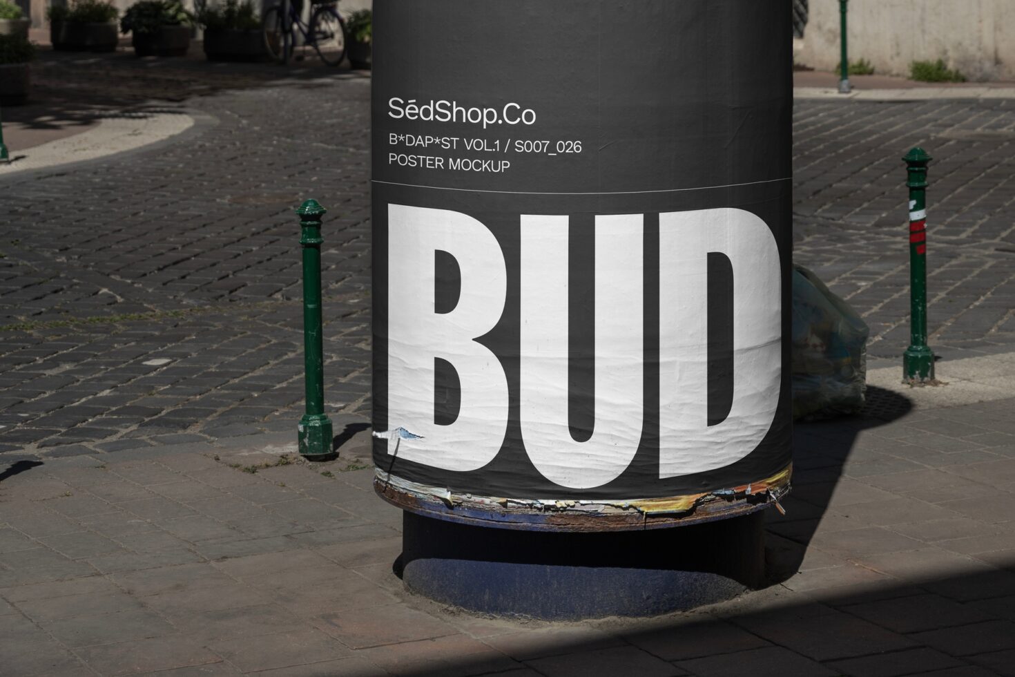 Urban poster mockup displayed on a street pillar with bold text BUD. Perfect for designers showcasing advertising design or typography in urban settings.