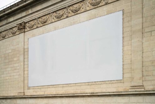 Blank billboard mockup on ornate stone wall ideal for advertising branding presentations. High-resolution template for graphic designers.