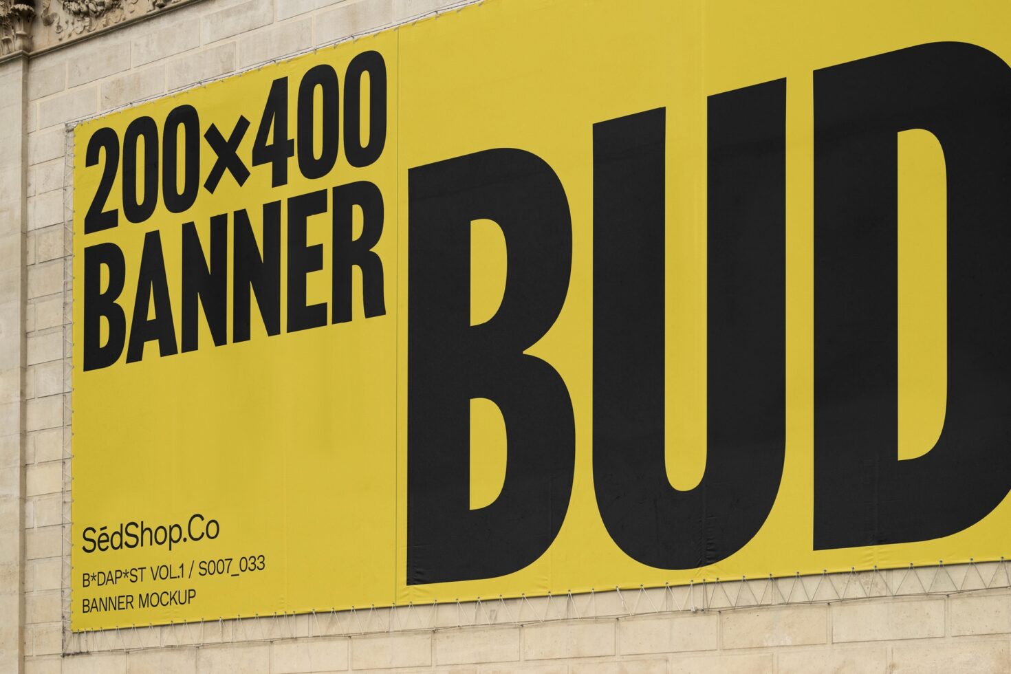 Large yellow banner mockup on stone wall featuring bold black text 200x400 dimensions ideal for designers marketing outdoor advertisements graphics.