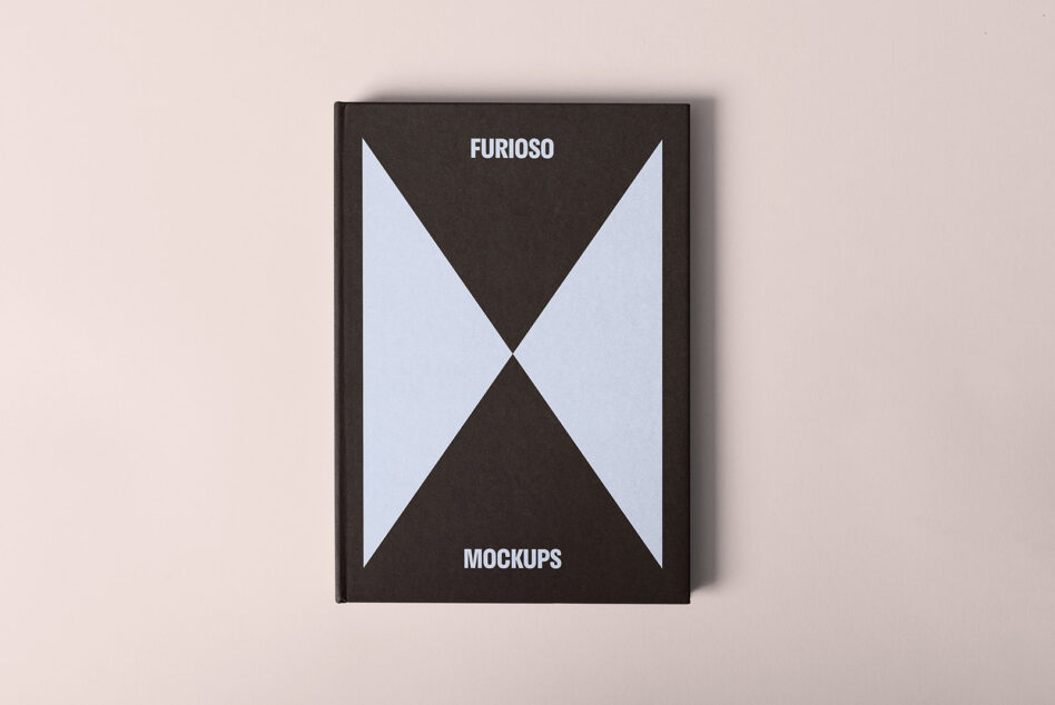 Mockup of a hardcover book with a minimalist geometric design featuring bold black and white triangles. Ideal for showcasing design and branding projects.