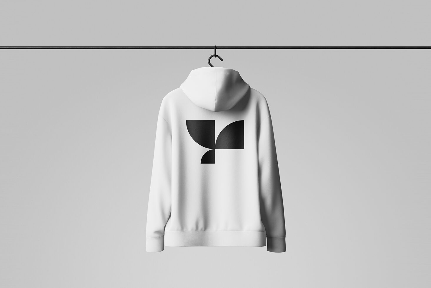 White hoodie with minimalist black geometric logo on back, hanging on rail. Perfect for mockup designs, apparel branding, and graphic design projects.