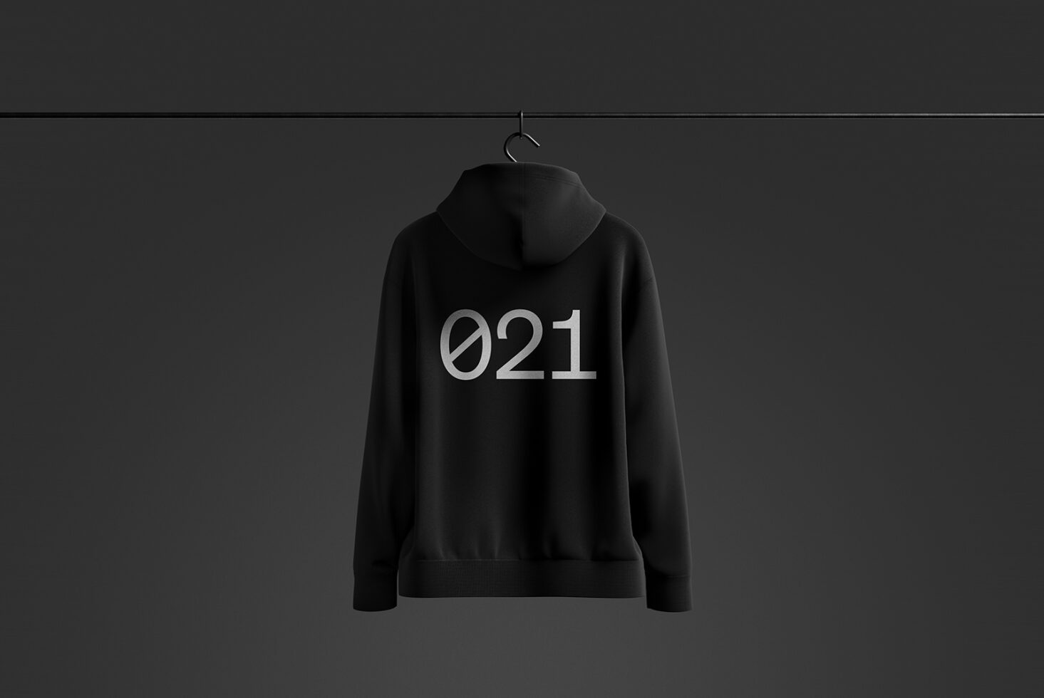 Black hoodie mockup on dark background featuring minimalist 021 text design; ideal for apparel design presentations and fashion branding templates.