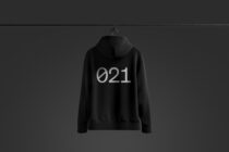 Black hoodie mockup on dark background featuring minimalist 021 text design; ideal for apparel design presentations and fashion branding templates.