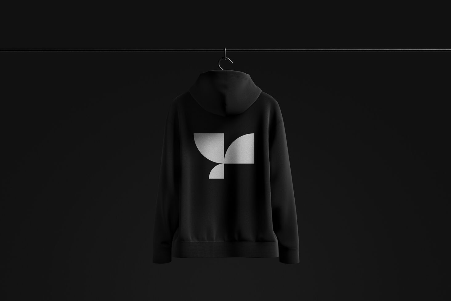 Black hoodie mockup on hanger featuring geometric logo design. Suitable for apparel branding presentations. Keywords: mockup design logo apparel.