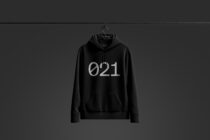 Black hoodie on hanger with silver 021 graphic centered