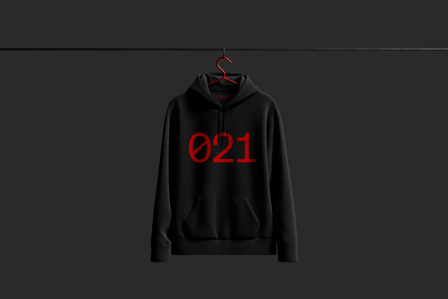 Black hoodie mockup featuring bold red numbers 021 hanging on a rack. Ideal for apparel designers, branding projects, and online store presentations.